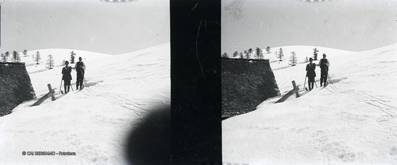 Skiatori foto ricordo vicino ad una baita sulla Torcola