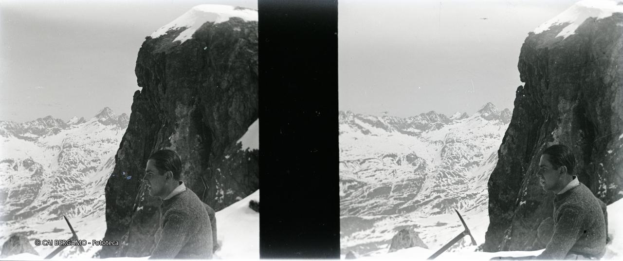 Dal Cabianca, alpinista di profilo con piccozza e sullo sfondo Diavolo e Diavolino