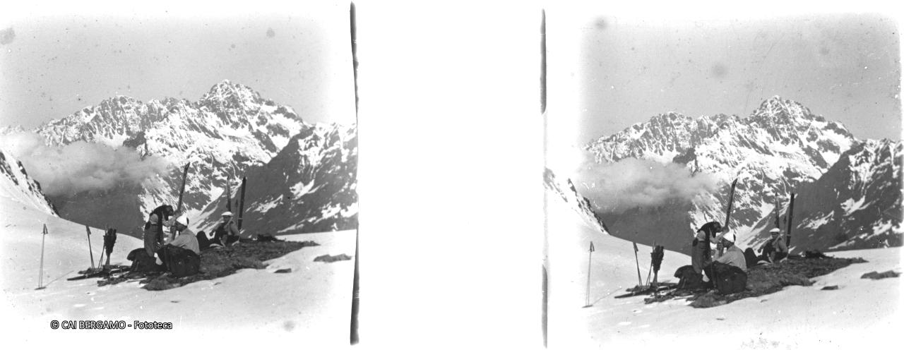 Skiatori al passo per sosta merenda e sistemazione ski, con il Coca sullo sfondo