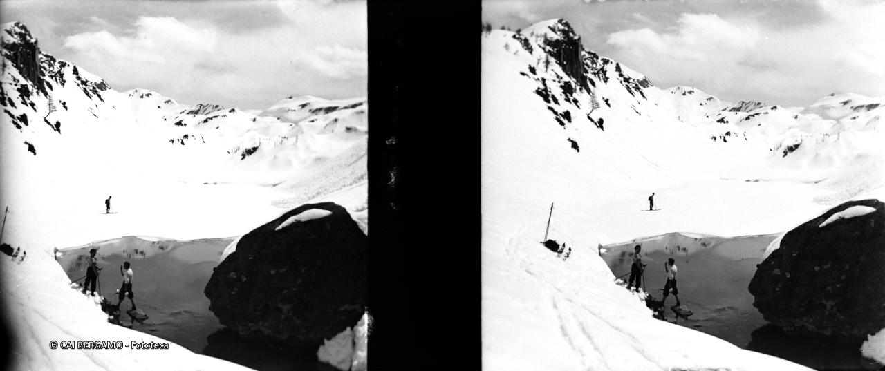 Sosta davanti a laghetto alpino tra la neve